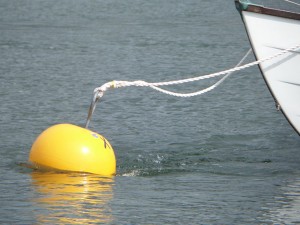 Boat moored using yellow rod mooring buoy